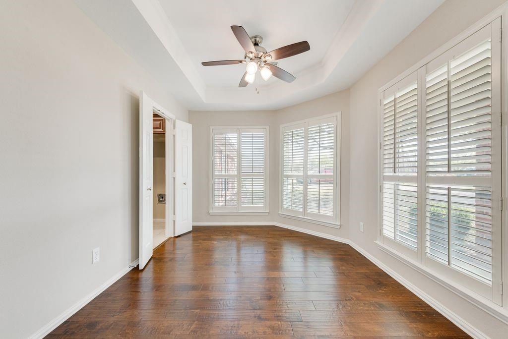 11374 Jennifer Circle Forney, TX 75126 - Photo 10 of 36 Dining room with a ceiling fan, dark wood-style floors, and a tray ceiling. This room has access to the kitchen.