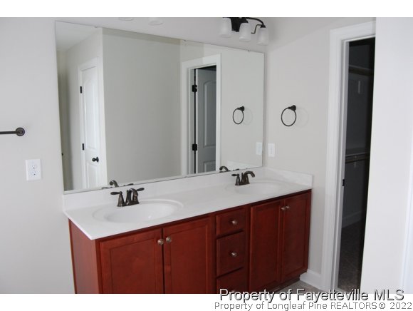 1024 Micahs Way North Spring Lake, NC 28390 - Photo 19 of 25 a bathroom with a sink vanity granite and a mirror