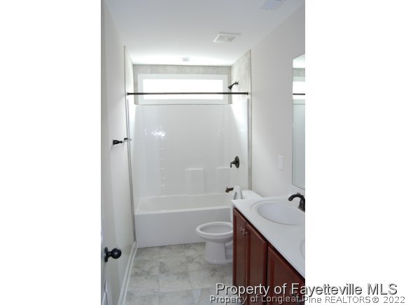 1024 Micahs Way North Spring Lake, NC 28390 - Photo 23 of 25 a bathroom with a sink a toilet and a bathtub