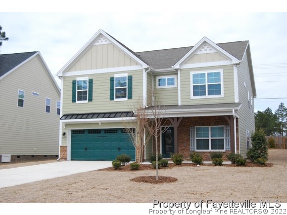 1024 Micahs Way North Spring Lake, NC 28390 - Photo 24 of 25 a front view of a house with a yard and a garage