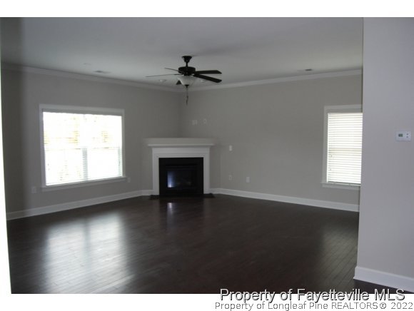 1024 Micahs Way North Spring Lake, NC 28390 - Photo 7 of 25 a view of an empty room with a window and wooden floor