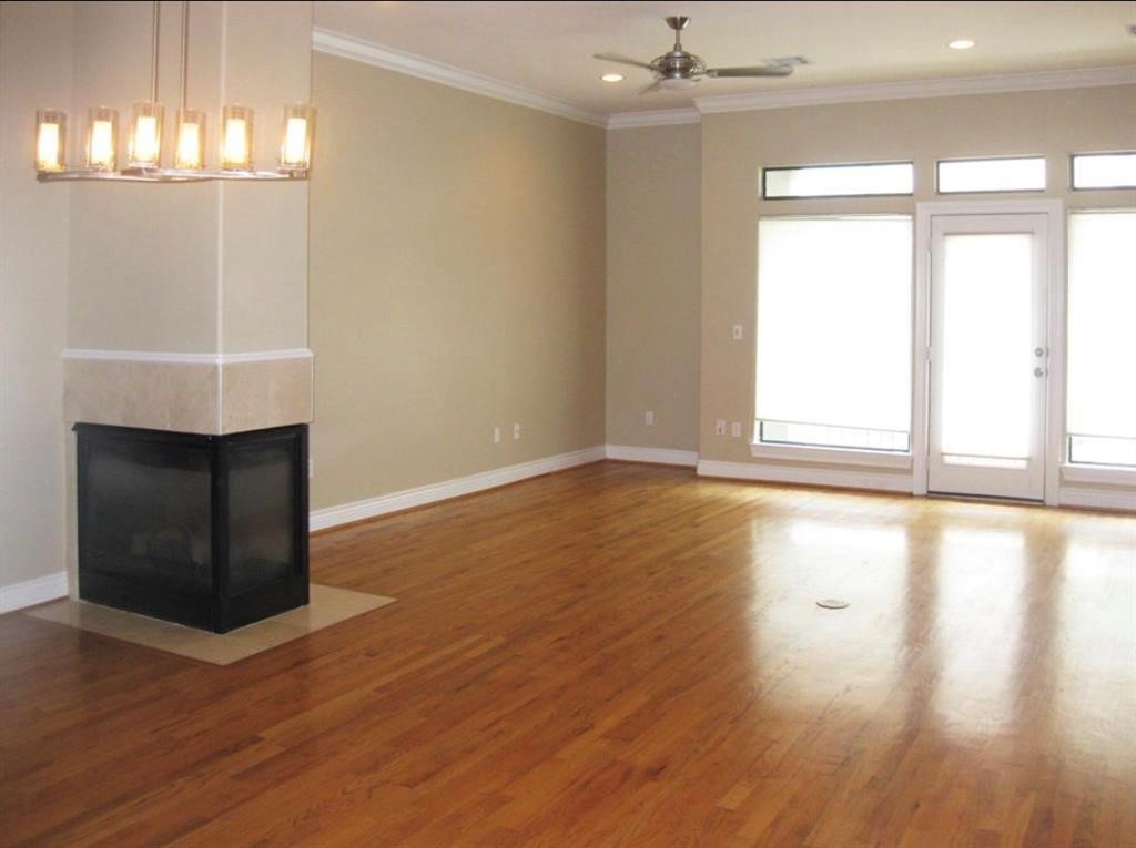 1623 Stuart Street Houston, TX 77004 - Photo 6 of 24 2nd Level - Living, Dining, Kitchen, Breakfast and 1/2 bath are located on this floor. View of the Living room with a 2 sided gas log fireplace