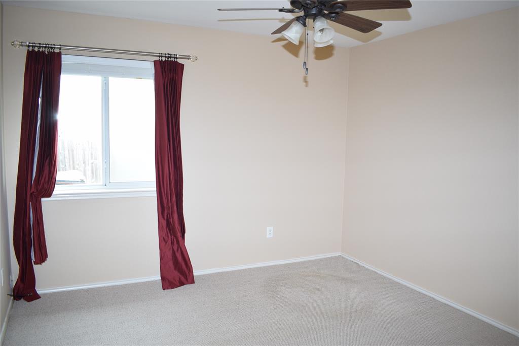 3688 Spring Canyon Trail Round Rock, TX 78681 - Photo 14 of 17 Carpeted room featuring a white-framed window with burgundy drapes, a ceiling fan with light kit, and neutral wall paint