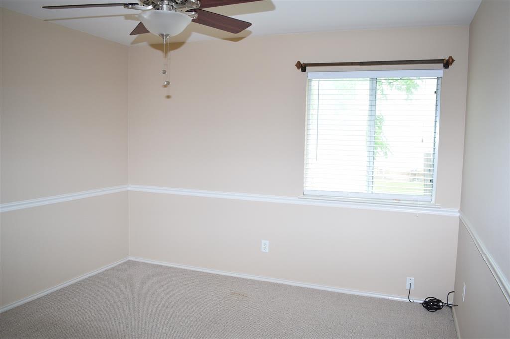 3688 Spring Canyon Trail Round Rock, TX 78681 - Photo 16 of 17 Room featuring a single window with horizontal blinds, neutral wall paint, and a textured carpeted floor