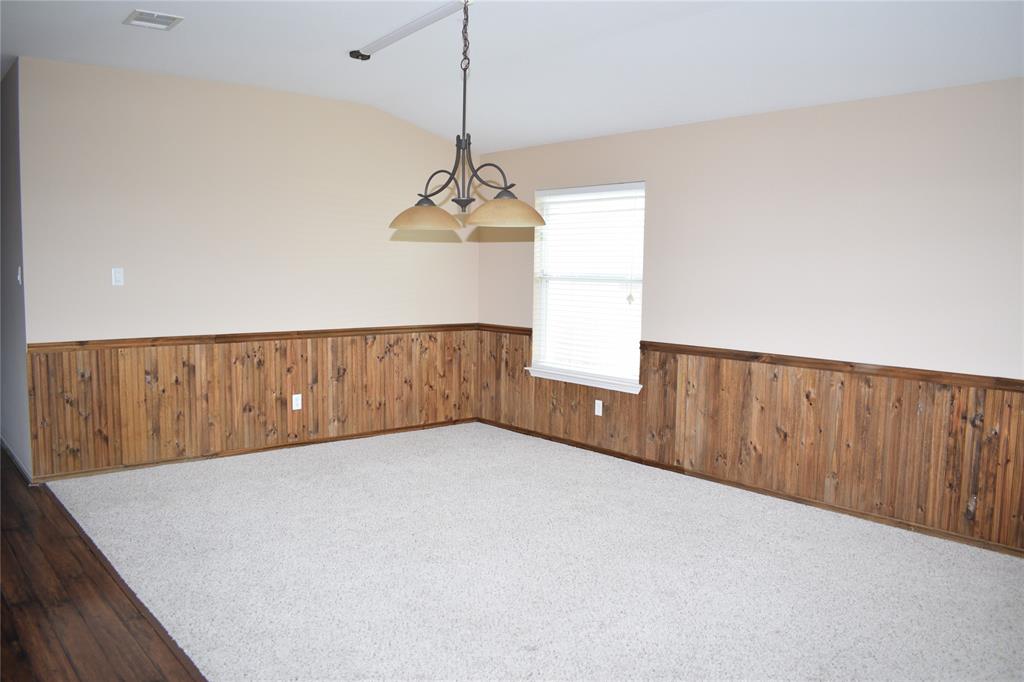 3688 Spring Canyon Trail Round Rock, TX 78681 - Photo 2 of 17 Spacious room featuring wood panel wainscoting and neutral-toned walls