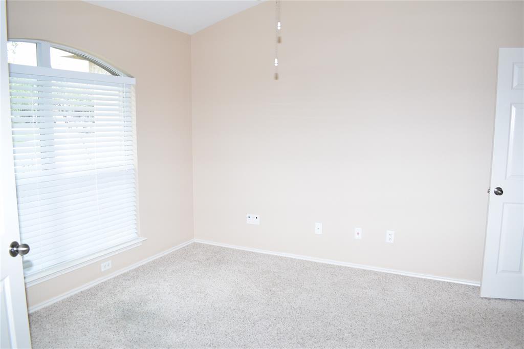 3688 Spring Canyon Trail Round Rock, TX 78681 - Photo 4 of 17 Carpeted room featuring a large window with an arched transom, horizontal blinds, and a neutral wall color