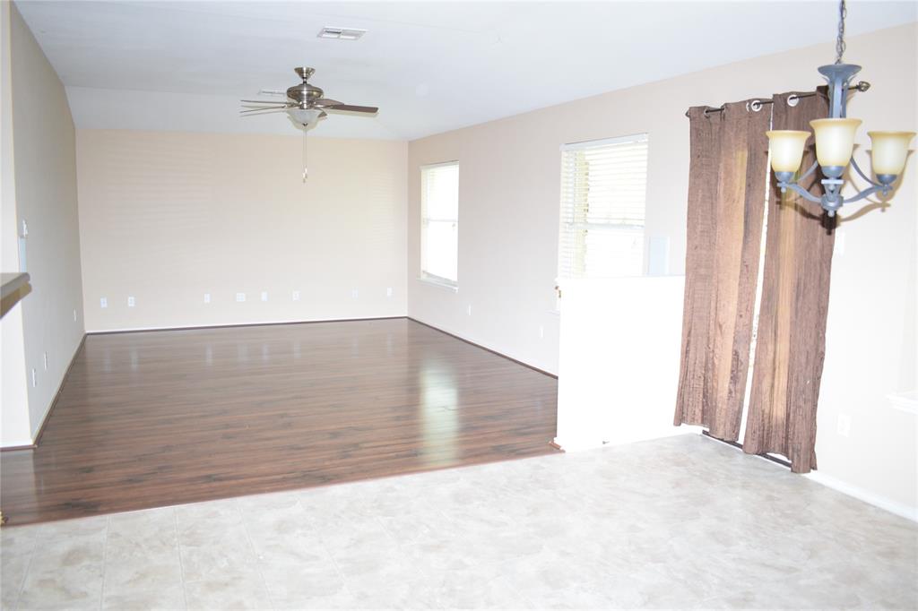 3688 Spring Canyon Trail Round Rock, TX 78681 - Photo 7 of 17 Spacious living area featuring wood-finish flooring, neutral wall tones, and an overhead ceiling fan