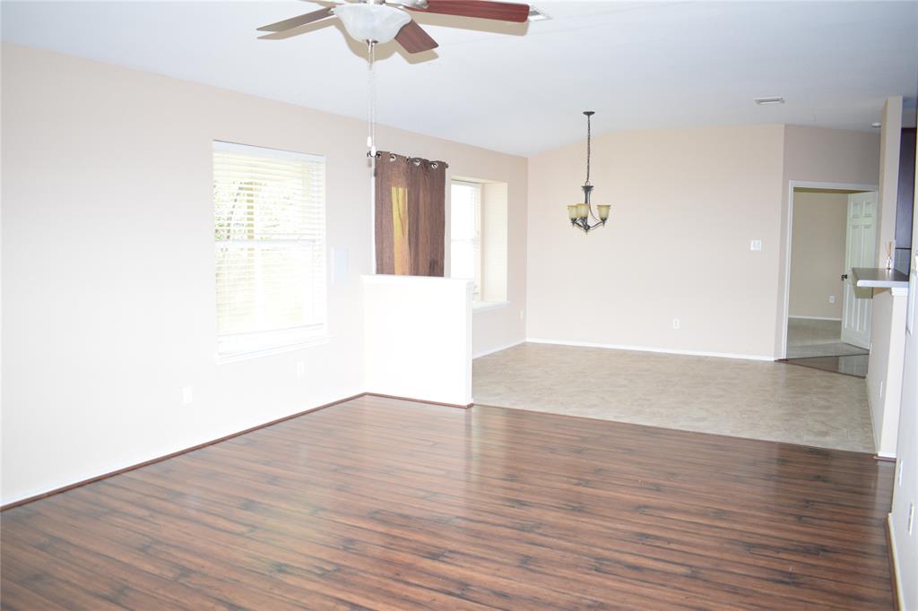 3688 Spring Canyon Trail Round Rock, TX 78681 - Photo 8 of 17 Spacious interior featuring wood-finish flooring, neutral paint, a ceiling fan, and multiple windows