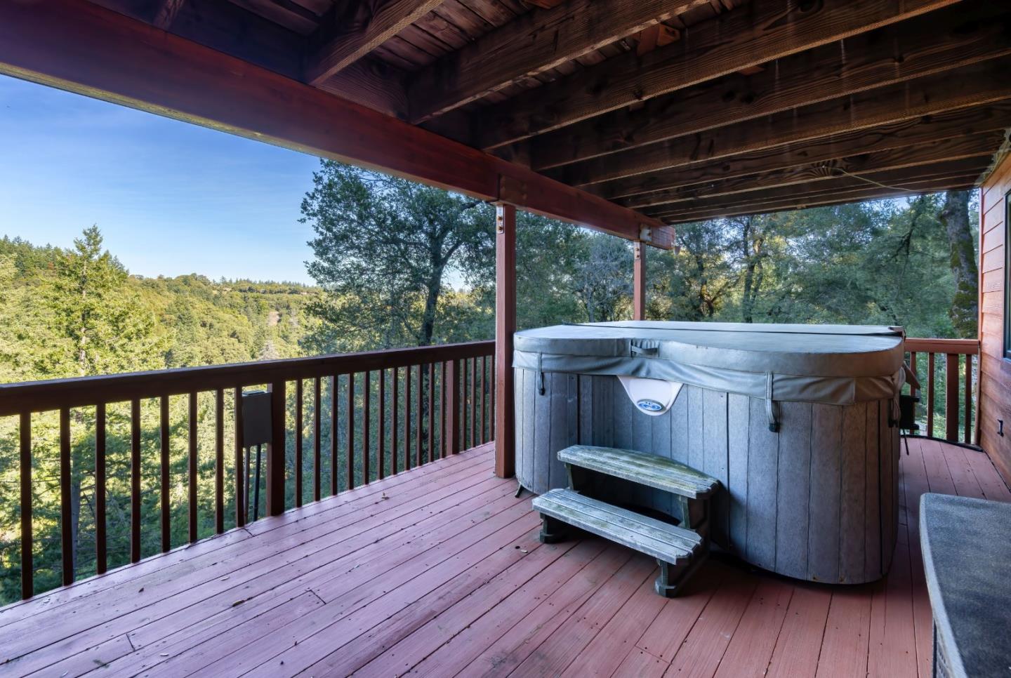 22125 Miller Ridge Road Los Gatos, CA 95033 - Photo 18 of 35 a view of a wooden deck with a table and chairs