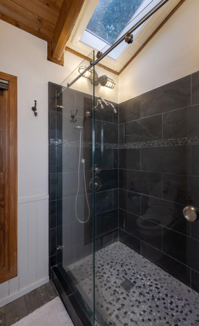 22125 Miller Ridge Road Los Gatos, CA 95033 - Photo 21 of 35 a bathroom with a glass shower door