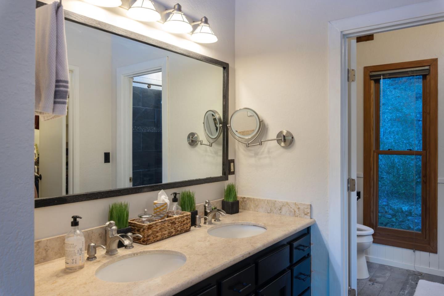 22125 Miller Ridge Road Los Gatos, CA 95033 - Photo 24 of 35 a bathroom with a granite countertop sink and a mirror