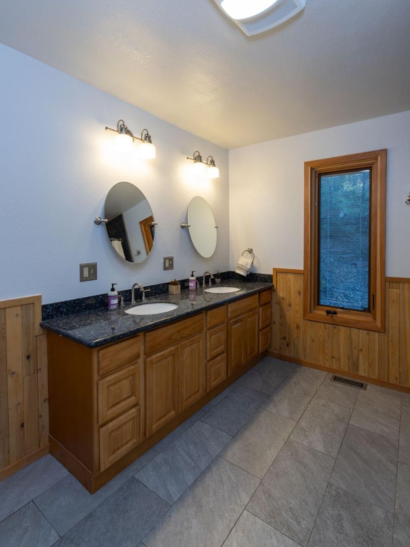 22125 Miller Ridge Road Los Gatos, CA 95033 - Photo 25 of 35 a kitchen with a sink a stove and mirror