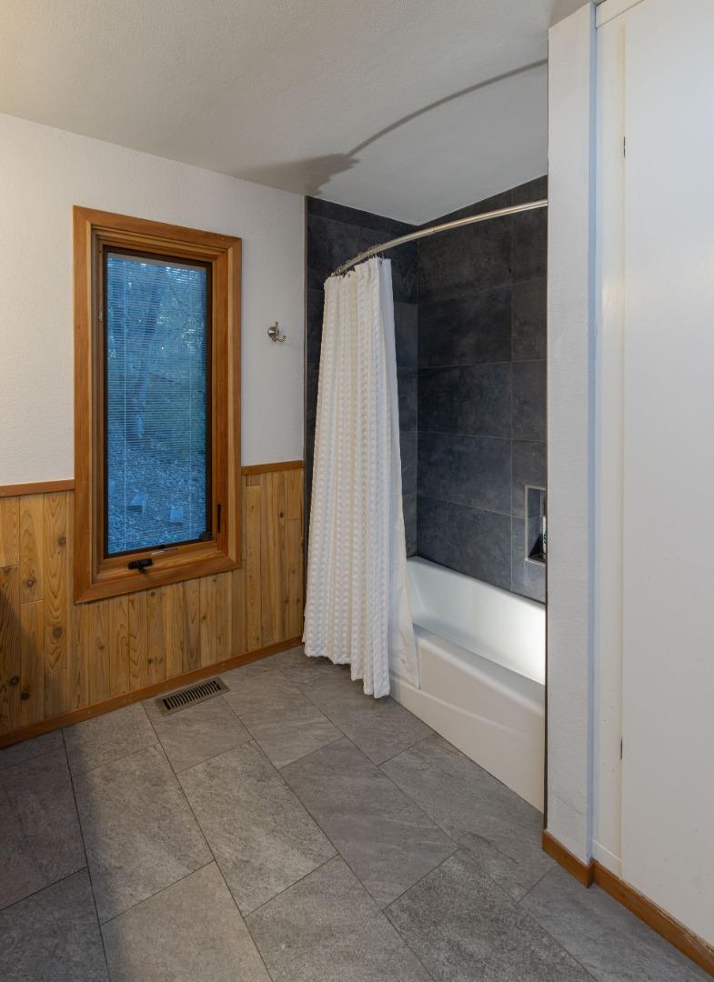 22125 Miller Ridge Road Los Gatos, CA 95033 - Photo 26 of 35 a bathroom with a bathtub and a shower