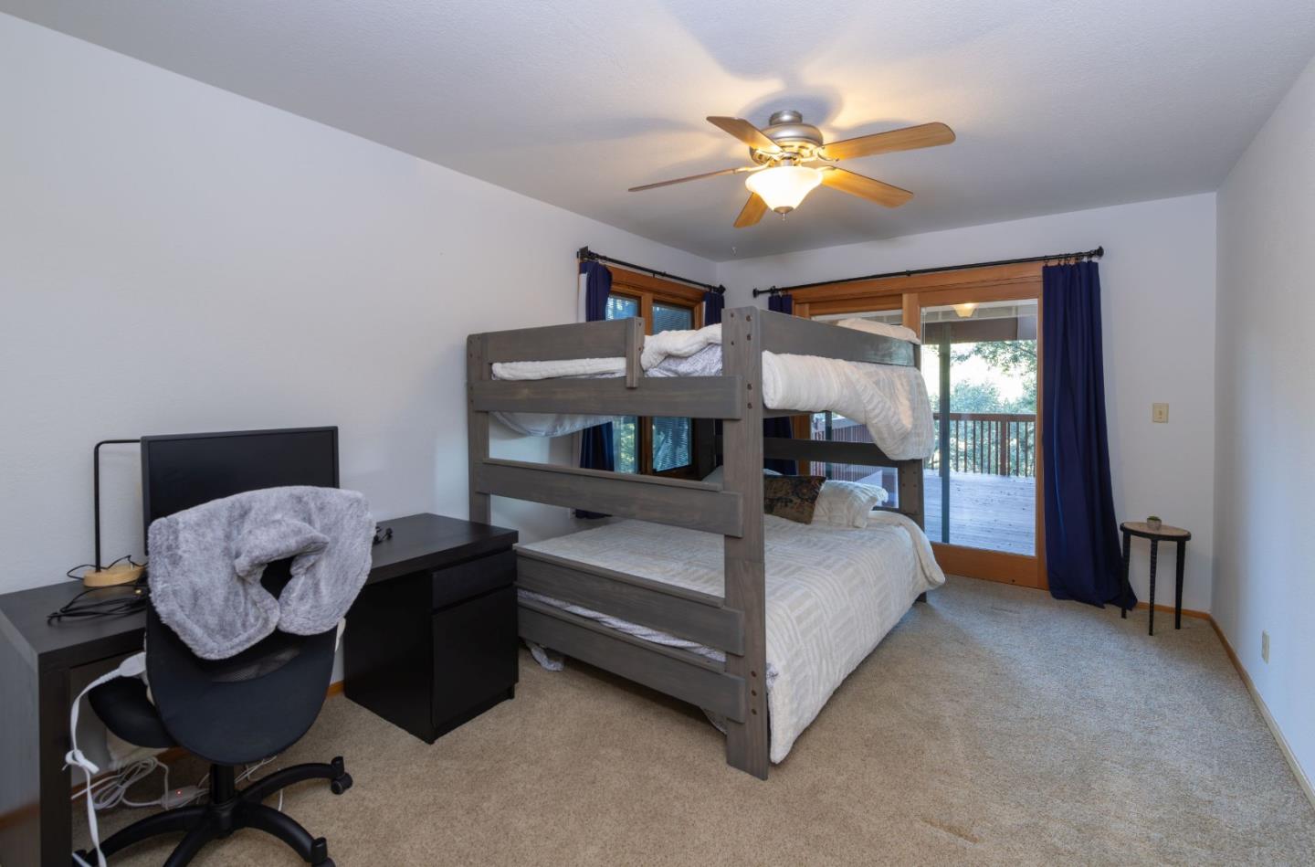 22125 Miller Ridge Road Los Gatos, CA 95033 - Photo 27 of 35 a bedroom with a bed and a chandelier