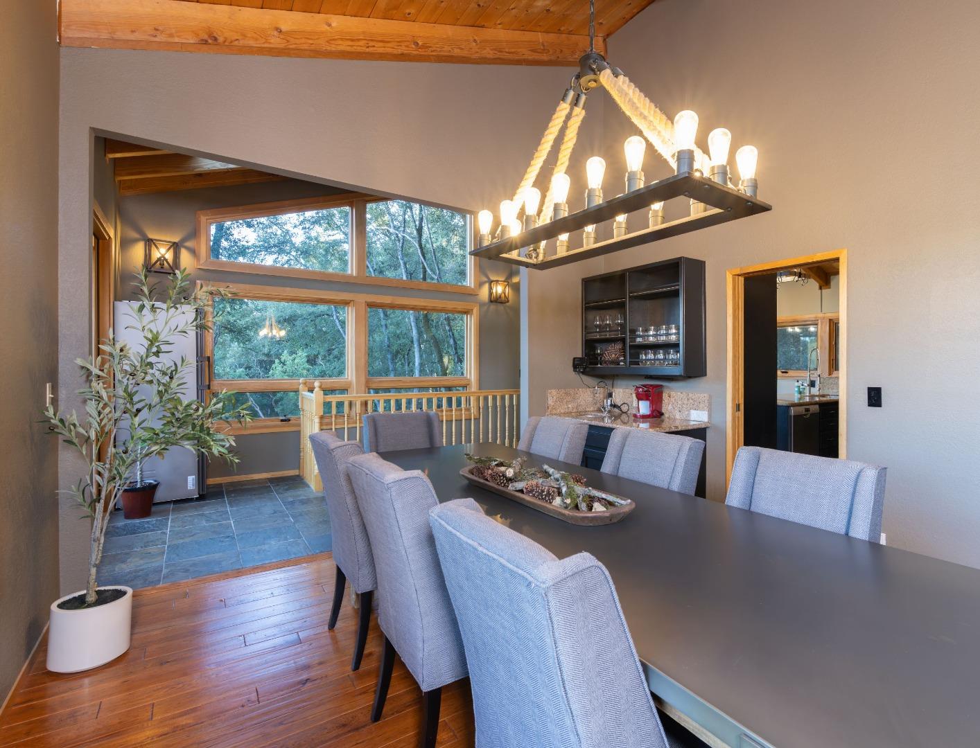 22125 Miller Ridge Road Los Gatos, CA 95033 - Photo 4 of 35 a view of a dining room with furniture a chandelier and wooden floor