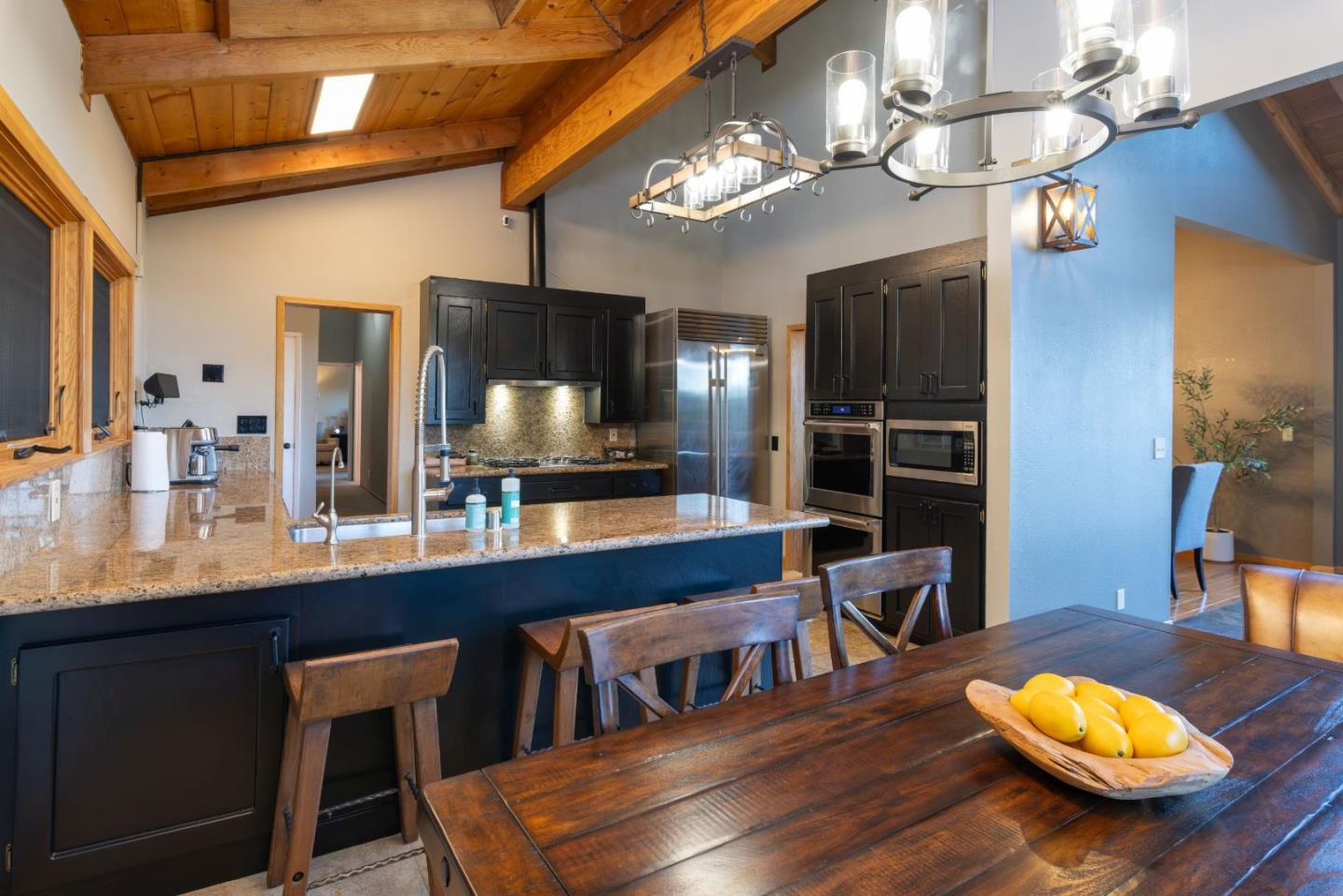 22125 Miller Ridge Road Los Gatos, CA 95033 - Photo 8 of 35 a kitchen with a dining table and chairs
