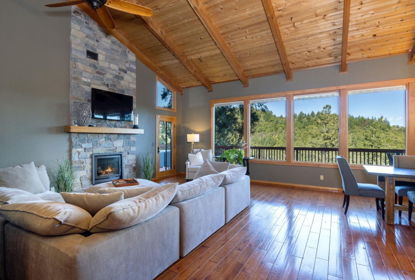 22125 Miller Ridge Road Los Gatos, CA 95033 - Photo 10 of 35 a living room with furniture a fireplace and a large window
