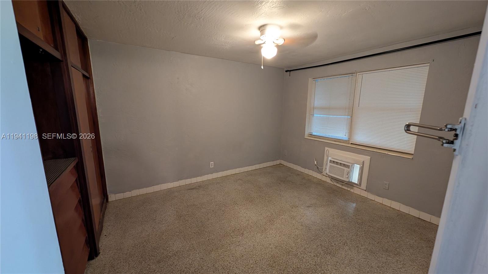 2024 Fillmore Street, Unit 1 Hollywood, FL 33020 - Photo 2 of 5 wooden floor in an empty room with a window