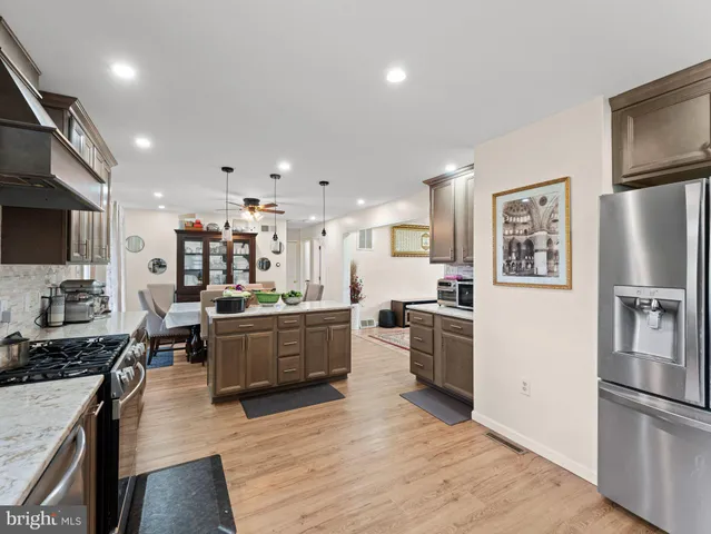 a large kitchen with a large counter top appliances and cabinets