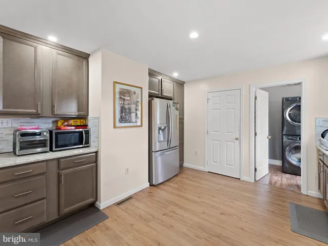 a kitchen with stainless steel appliances a stove refrigerator and a refrigerator