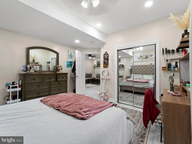 a large bedroom with a bed and a large mirror