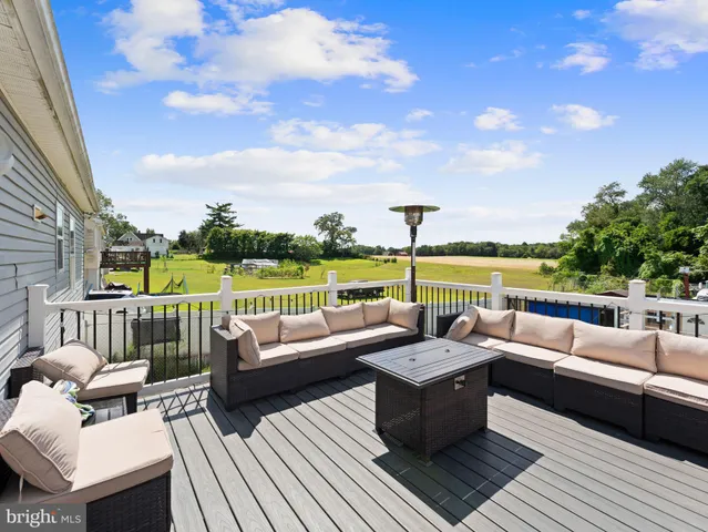 a balcony with wooden floor and furniture