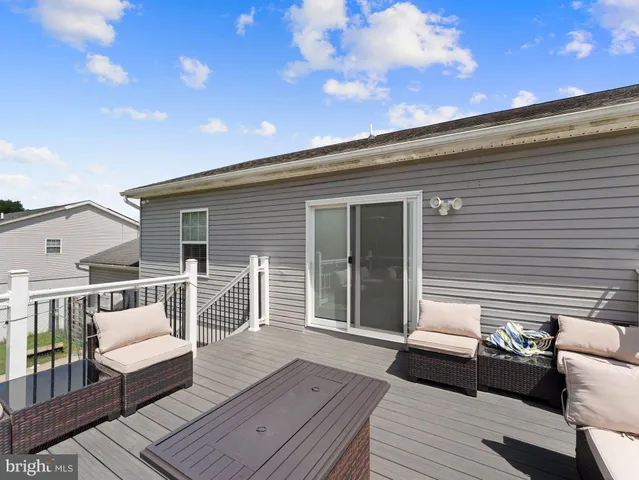 a balcony with wooden floor and furniture