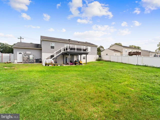a view of a house with a big yard and large trees