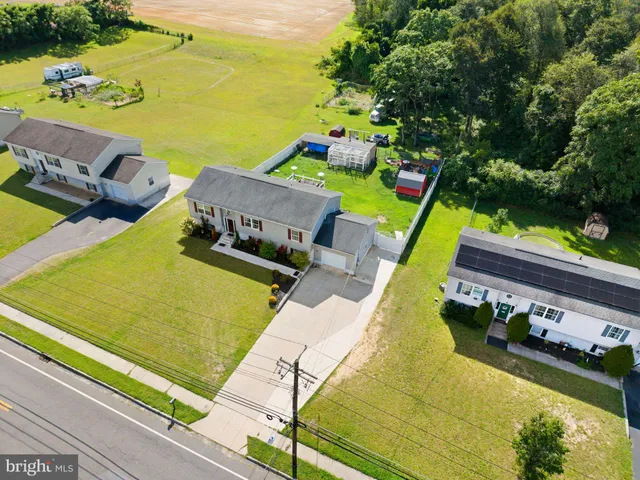 a view of a tennis ground with large trees
