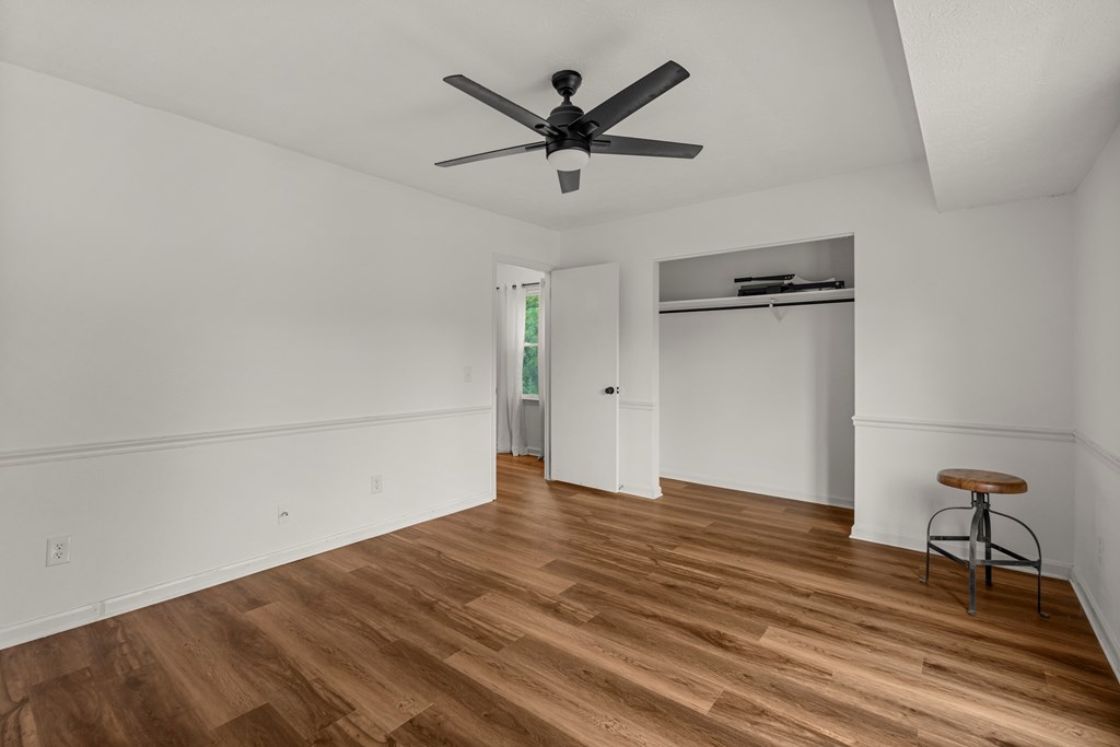 2133 13th Street Columbus, GA 31906 - Photo 13 of 15 a view of empty room with wooden floor and ceiling fan