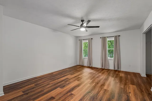 wooden floor in an empty room with a window
