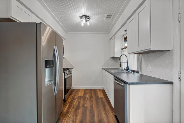 a kitchen with stainless steel appliances granite countertop a refrigerator and a sink