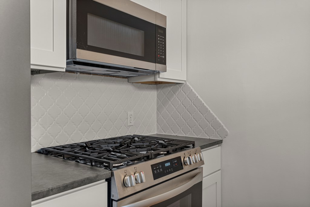 2133 13th Street Columbus, GA 31906 - Photo 5 of 15 a stove top oven sitting inside of a kitchen