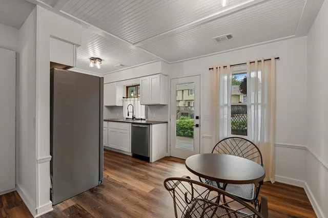 a kitchen with sink refrigerator and dining table