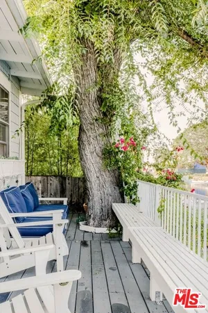 a view of balcony with wooden floor and outdoor seating