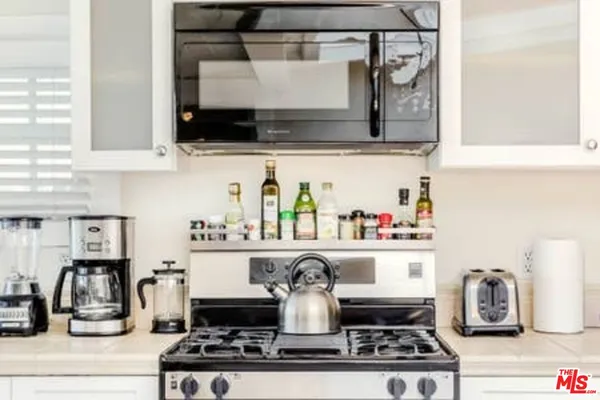 a kitchen with a stove and cabinets