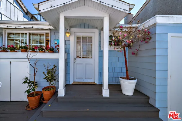 a front view of a house with outdoor seating