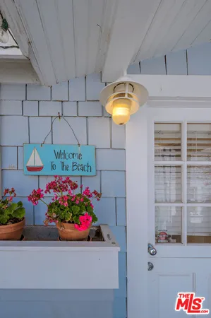 a front view of a house with a lot of flowers