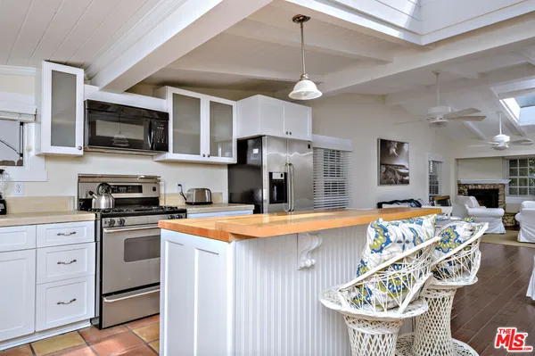 a kitchen with stainless steel appliances granite countertop a sink and cabinets