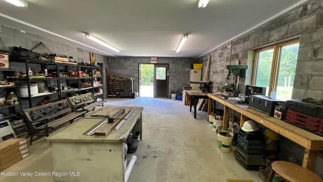 a living room with lots of furniture and clutter