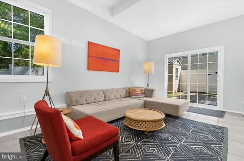 a living room with furniture and a lamp