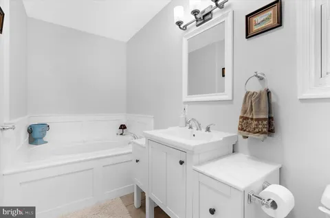 a bathroom with a sink a toilet and a mirror