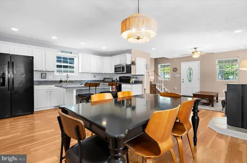 a view of a dining room with a table and chairs