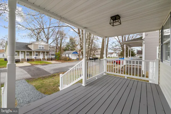 a view of a porch with wooden floor and iron fence