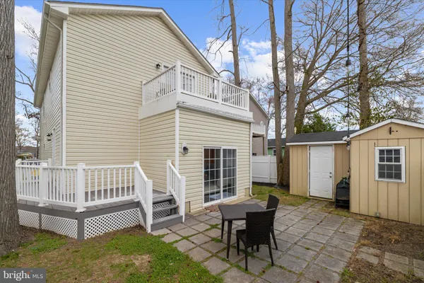 a view of a house with backyard and a chair
