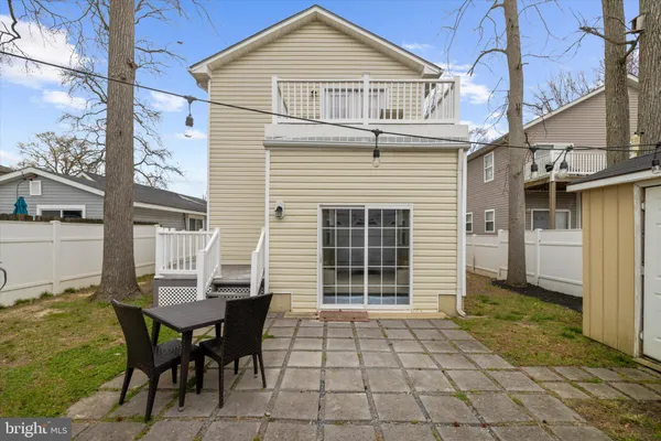 a view of a house with a table and chairs in patio