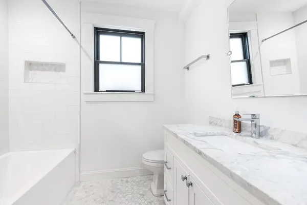 a living room with a sink and a washer dryer