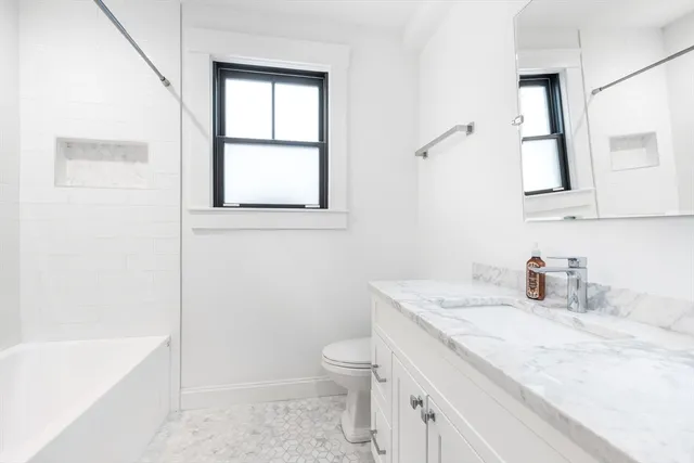 a living room with a sink and a washer dryer