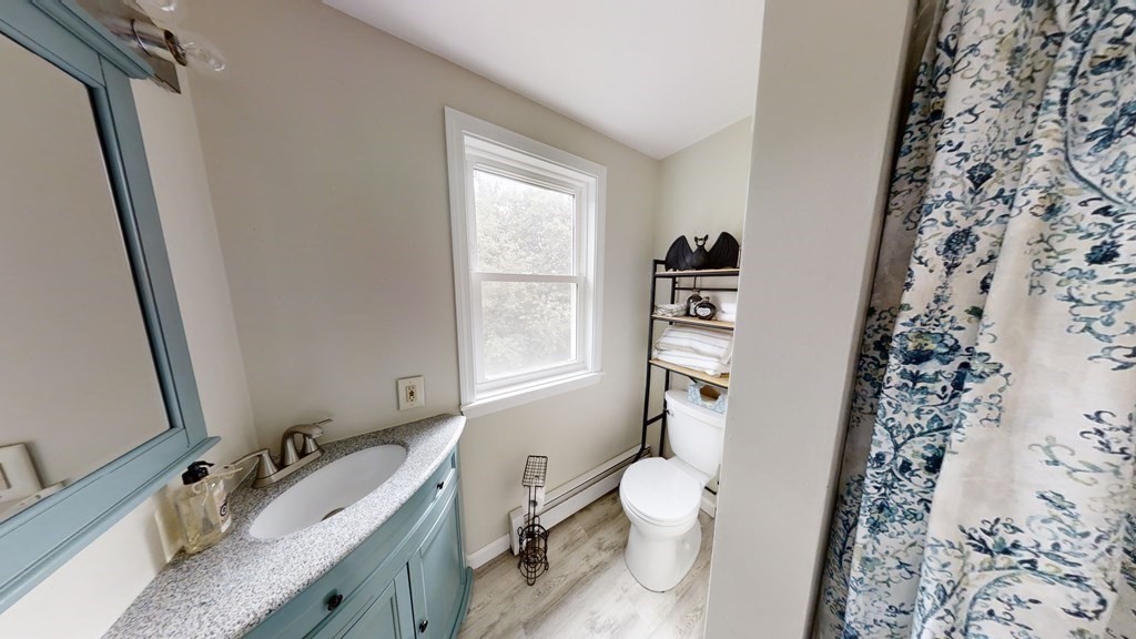 22 Cheyenne Road Worcester, MA 01606 - Photo 11 of 24 a bathroom with a granite countertop toilet sink and mirror