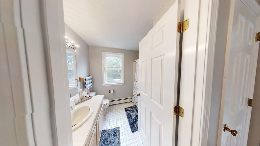 22 Cheyenne Road Worcester, MA 01606 - Photo 15 of 24 a en suite bathroom with a sink and mirror with bathtub